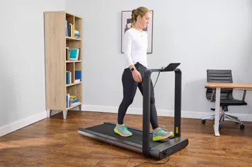 A close up of a person walking on the WalkingPad X21 Double-Fold Treadmill