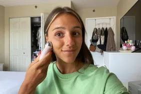 A person uses the NuFace Mini+ Start Kit