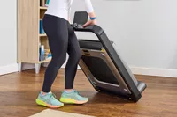A person moving the WalkingPad X21 Double-Fold Treadmill