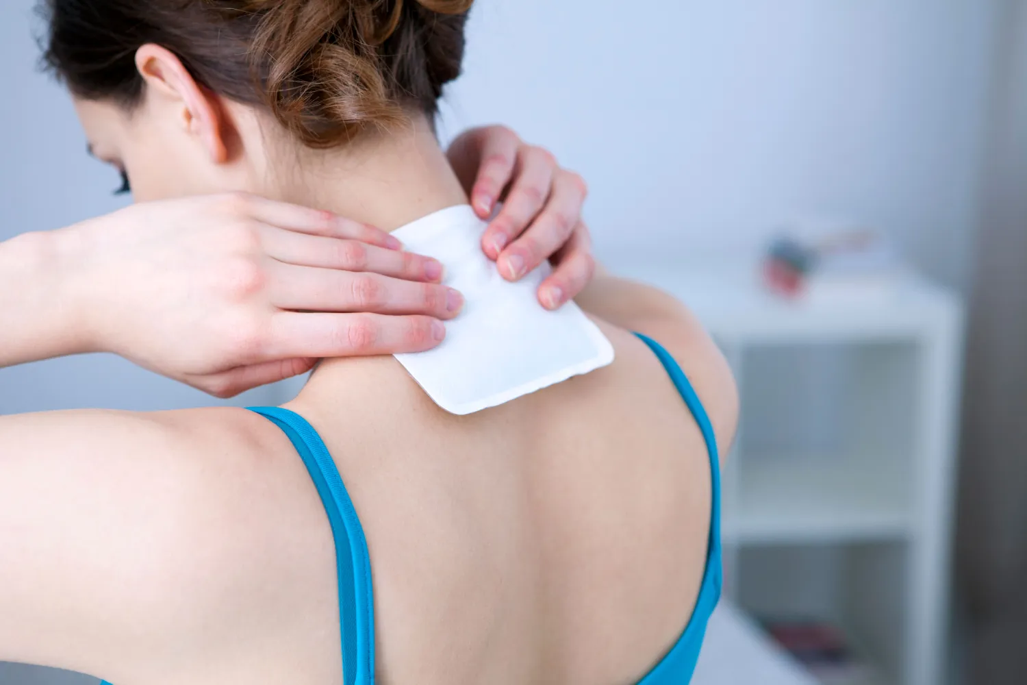 Person applying heat patch