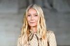 Gwyneth Paltrow smiling softly wearing a patterned blouse