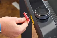 A person plugging the emergency cord to the WalkingPad X21 Double-Fold Treadmill