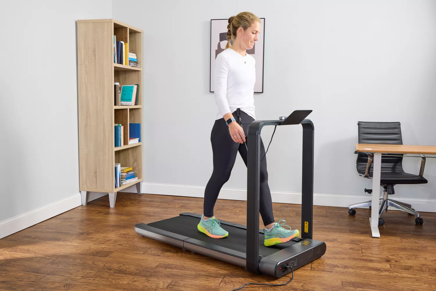 A close up of a person walking on the WalkingPad X21 Double-Fold Treadmill