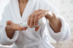 Mature Person applying moisturizer