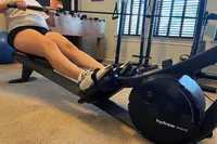A person exercises using the Hydrow Wave Rowing Machine