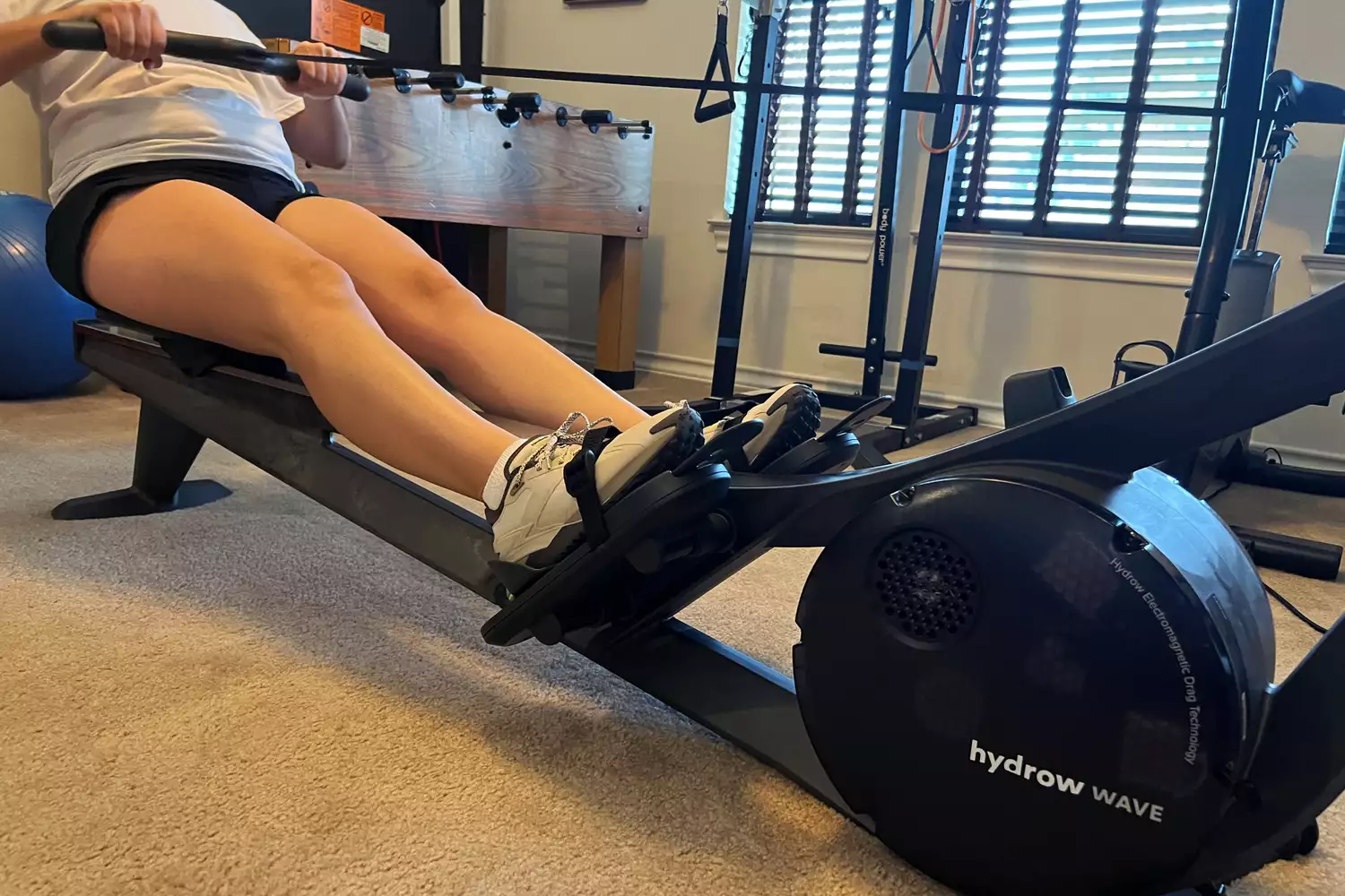 A person exercises using the Hydrow Wave Rowing Machine