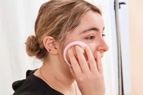 Person using the Foreo UFO 2 on their cheek