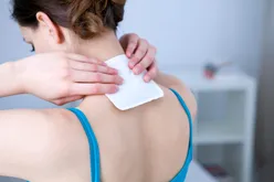 Person applying heat patch