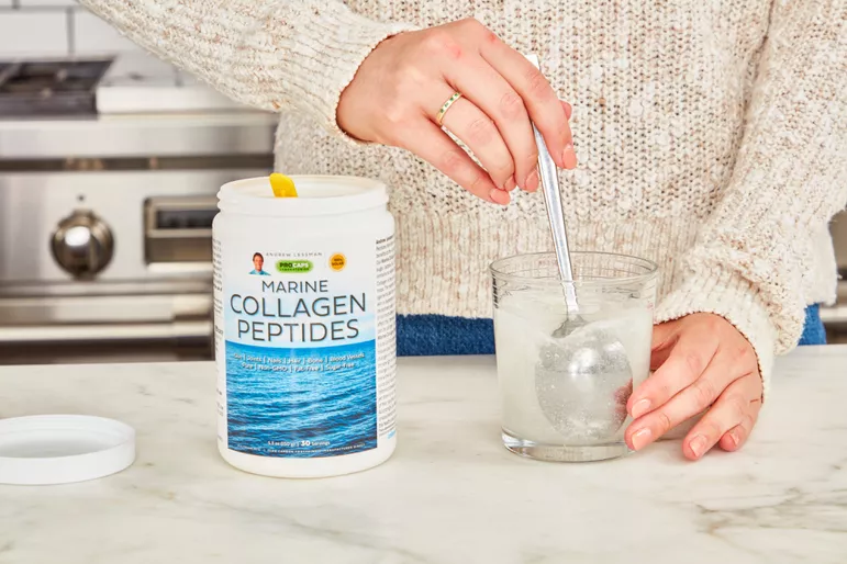 Hands stirring Procaps Marine Collagen Peptides into a glass of water