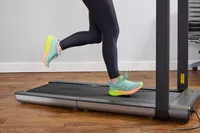 A close up of a person running on the WalkingPad X21 Double-Fold Treadmill