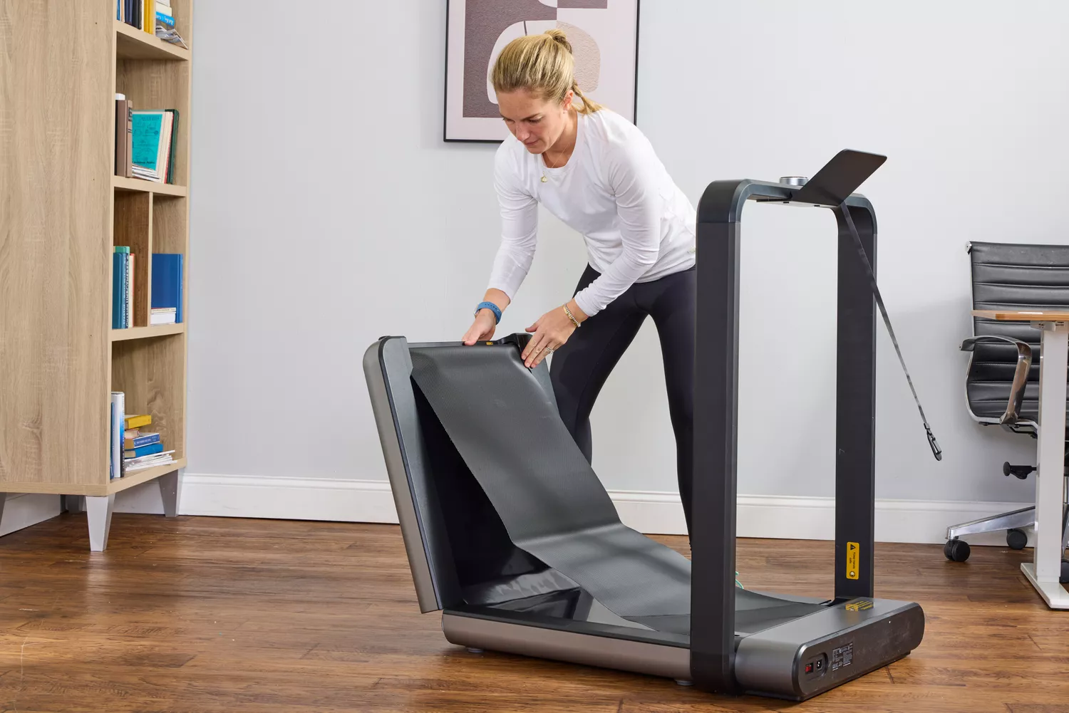A person unfolding the WalkingPad X21 Double-Fold Treadmill