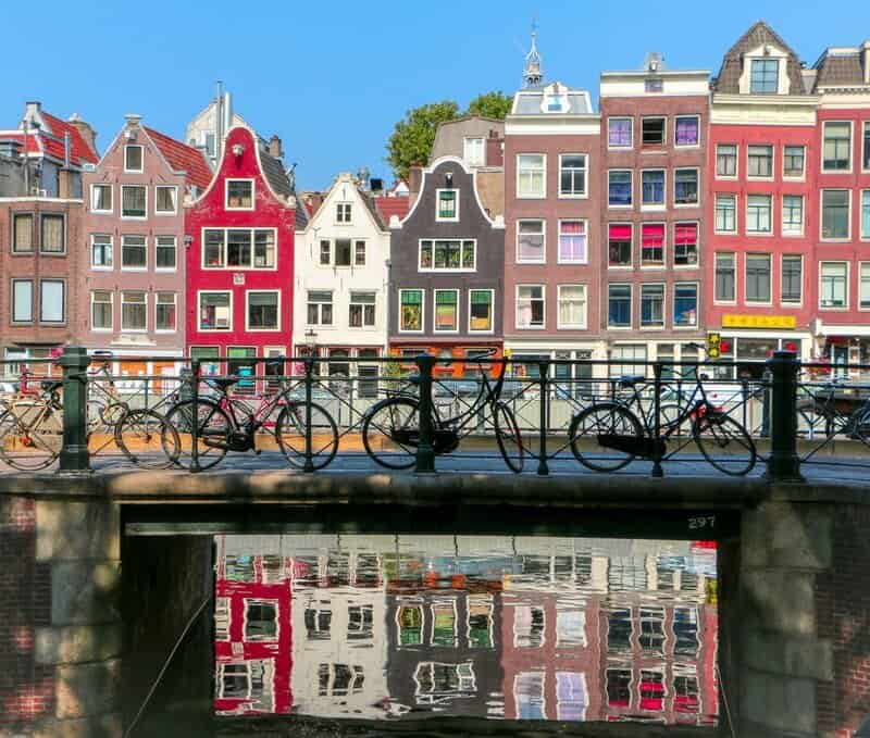 houses with bikes in front on a bridge in Amsterdam